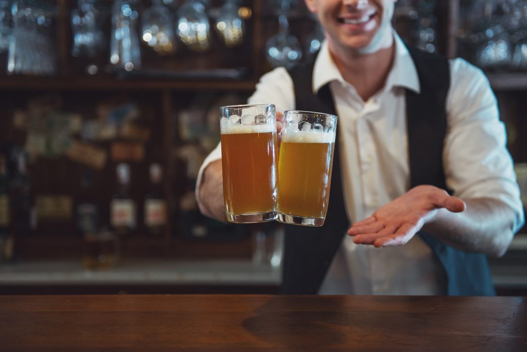 bartender holding two beers